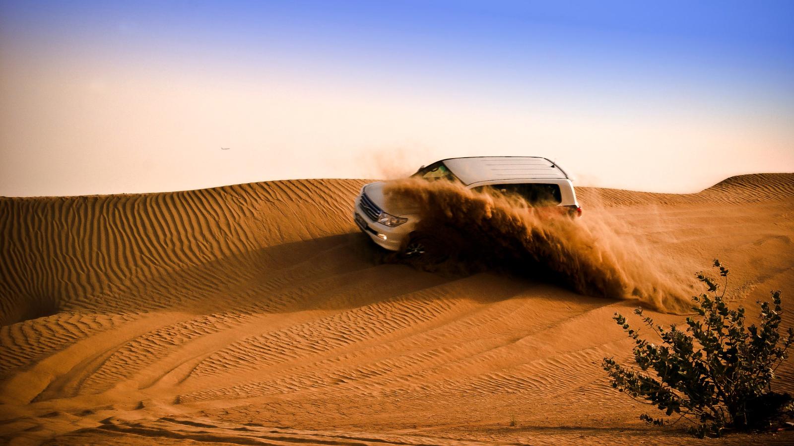 Geländewagen auf einer goldenen Düne bei Dubai