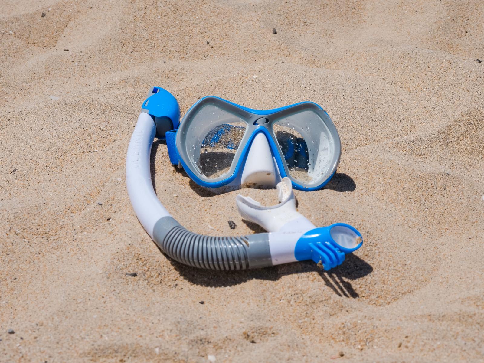 Maske, Schnorchel neben einem tropischen Strand mit türkisblauem Wasser
